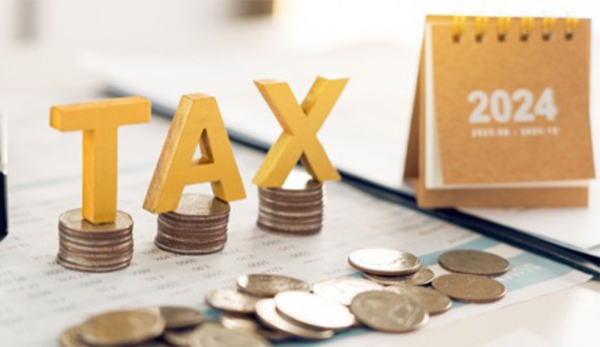 2024 tax planning concept with coins, TAX letters, and calendar